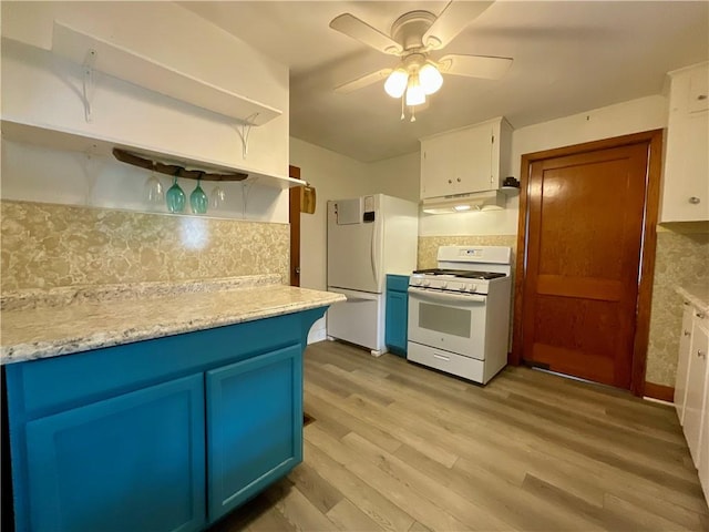 2 Washington St, North Dansville, NY 14437 - kitchen featuring white appliances, blue cabinetry, open shelves, under cabinet range hood, and decorative backsplash