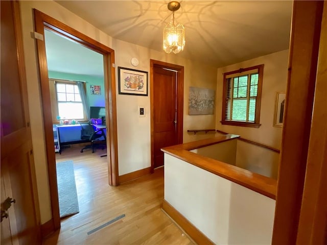 2 Washington St, North Dansville, NY 14437 - corridor featuring light wood-style floors, a chandelier, and an office area