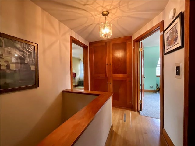 2 Washington St, North Dansville, NY 14437 - corridor with light wood-style flooring and a chandelier