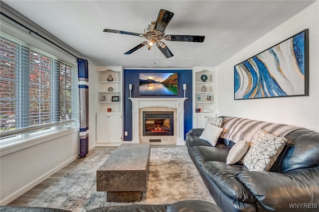 1416 99th St, Niagara Falls, NY 14304 - living room featuring a ceiling fan, a glass covered fireplace, built in shelves, and wood finished floors