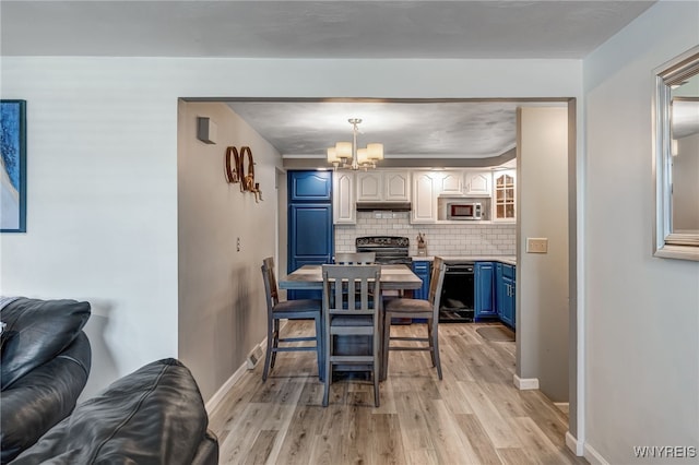 1416 99th St, Niagara Falls, NY 14304 - dining space with light wood-type flooring and a chandelier