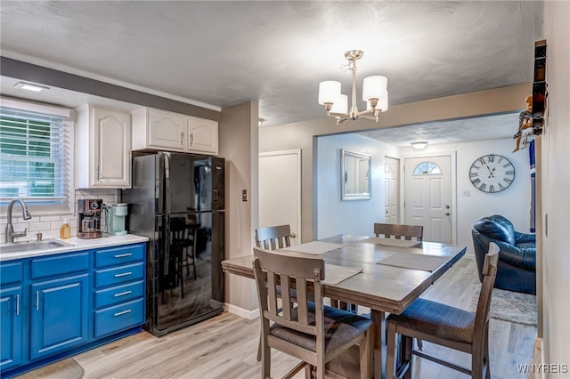 1416 99th St, Niagara Falls, NY 14304 - dining room featuring light wood-type flooring and a chandelier