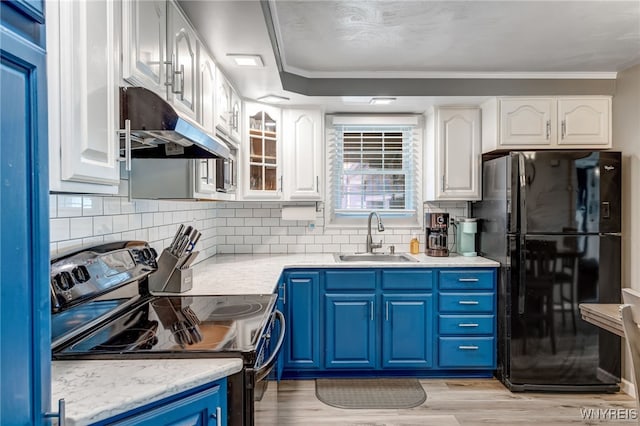 1416 99th St, Niagara Falls, NY 14304 - kitchen with black appliances, under cabinet range hood, blue cabinets, white cabinets, and ornamental molding