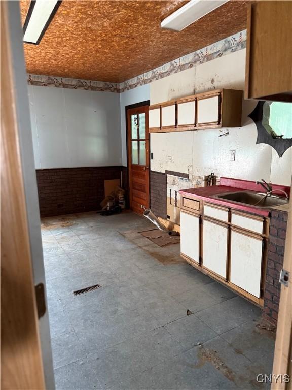 211 W Park St, Lenox, NY 13032 - kitchen with a sink and white cabinetry