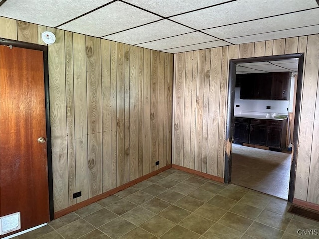 211 W Park St, Lenox, NY 13032 - empty room featuring wooden walls and dark tile patterned floors