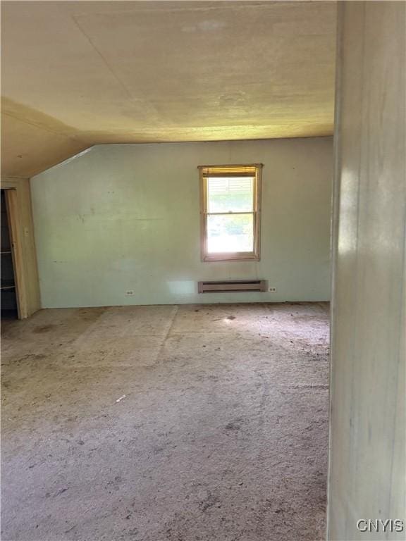 211 W Park St, Lenox, NY 13032 - carpeted spare room featuring baseboard heating and vaulted ceiling