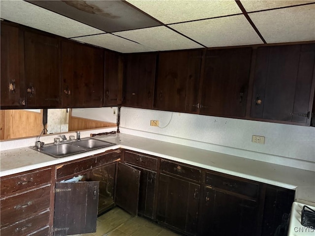 211 W Park St, Lenox, NY 13032 - kitchen with a drop ceiling, light countertops, and dark brown cabinets