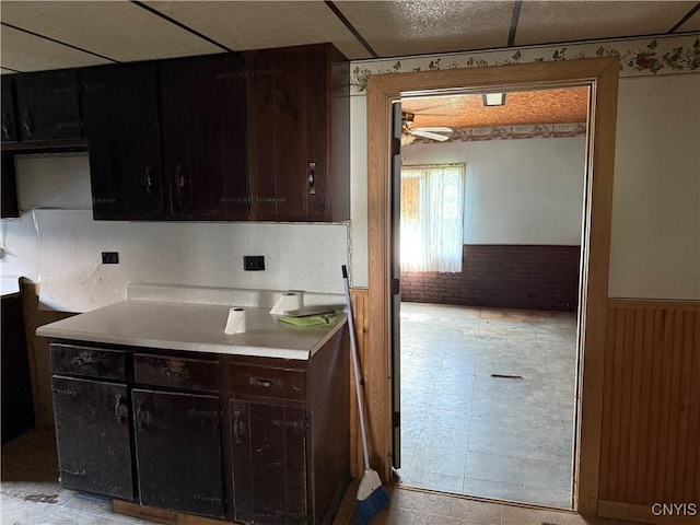 211 W Park St, Lenox, NY 13032 - kitchen with wainscoting, light countertops, and ceiling fan