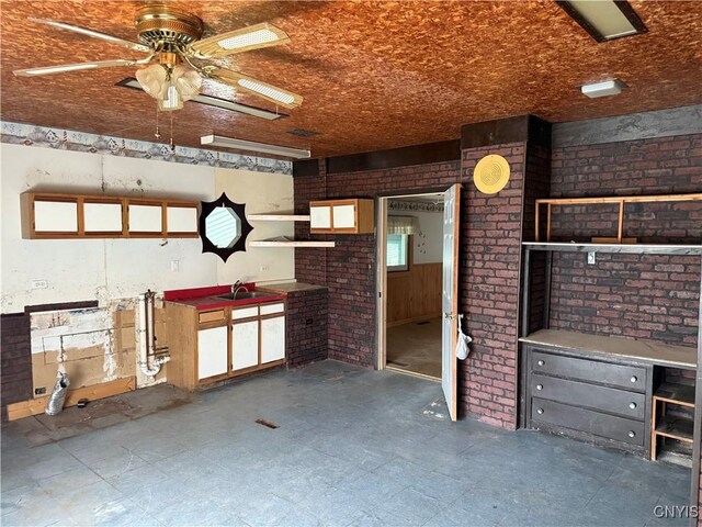 211 W Park St, Lenox, NY 13032 - unfurnished living room featuring a ceiling fan, brick wall, and tile patterned floors