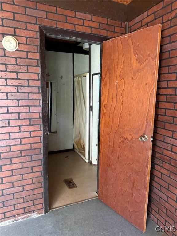 211 W Park St, Lenox, NY 13032 - interior space featuring brick wall