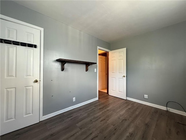 890 Holdridge St, Southport, NY 14904 - unfurnished bedroom featuring baseboards and dark wood-type flooring