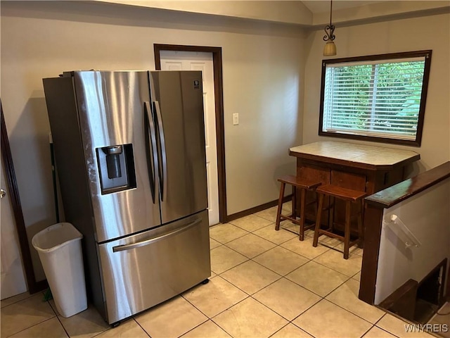 38 Hines St, Buffalo, NY 14220 - kitchen featuring stainless steel refrigerator with ice dispenser, light tile patterned floors, and lofted ceiling