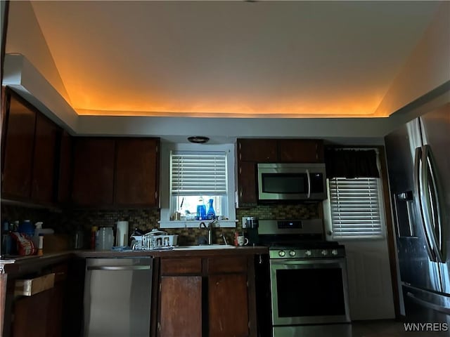 38 Hines St, Buffalo, NY 14220 - kitchen with appliances with stainless steel finishes, dark brown cabinetry, tasteful backsplash, and a raised ceiling