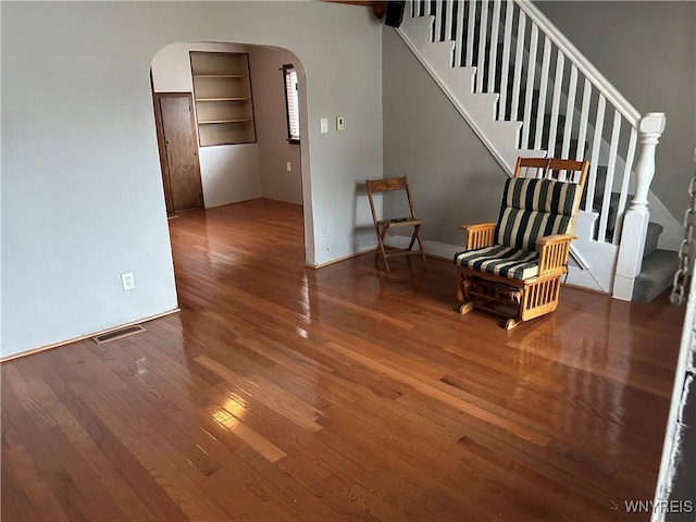 38 Hines St, Buffalo, NY 14220 - sitting room featuring arched walkways, wood-type flooring, and stairs