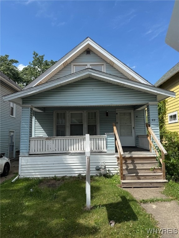 83 Custer St, Buffalo, NY 14214 - view of front of home with covered porch and a front lawn