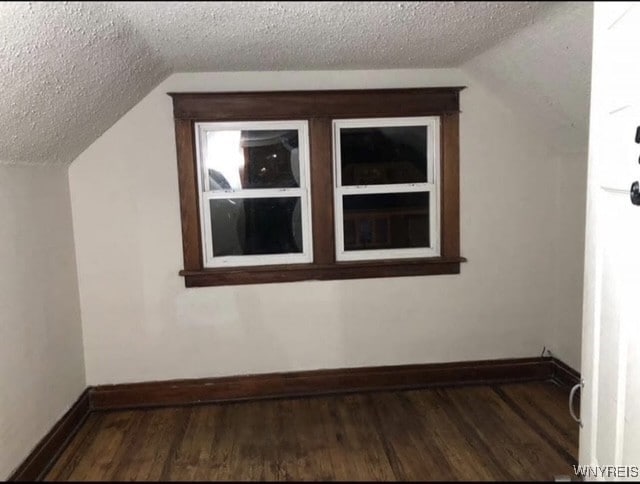 83 Custer St, Buffalo, NY 14214 - bonus room with lofted ceiling, a textured ceiling, and wood finished floors