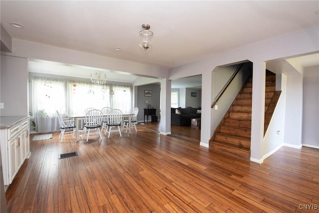 1109 Church Rd, Lysander, NY 13027 - dining space featuring stairs, a chandelier, and wood finished floors