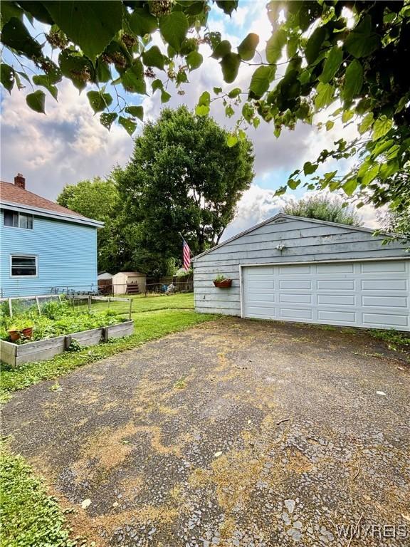 39 Klas Ave, West Seneca, NY 14224 - detached garage featuring a garden