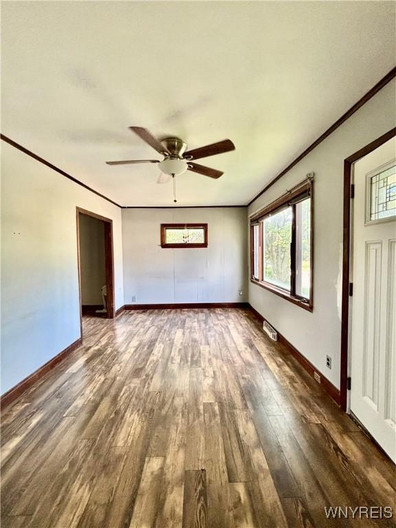 39 Klas Ave, West Seneca, NY 14224 - unfurnished living room with wood finished floors, ornamental molding, and a ceiling fan