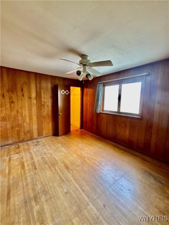 39 Klas Ave, West Seneca, NY 14224 - spare room with light wood-type flooring, a ceiling fan, and wood walls