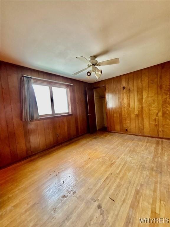 39 Klas Ave, West Seneca, NY 14224 - spare room featuring light wood-style floors, wooden walls, and ceiling fan