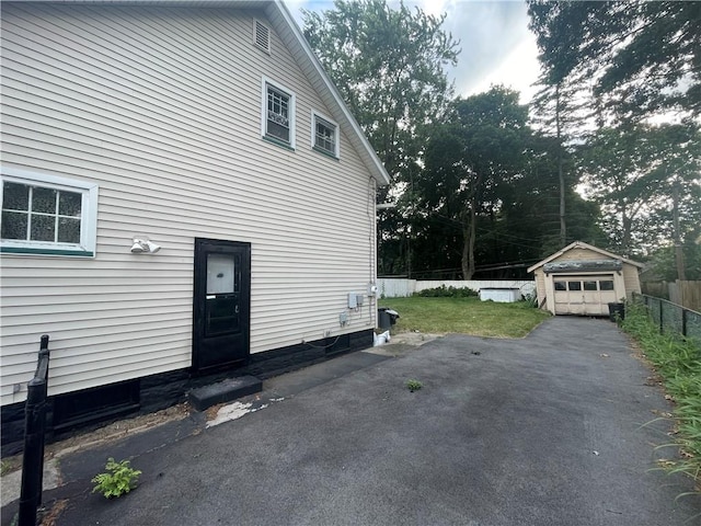 37 Outlook Dr, Irondequoit, NY 14622 - view of home's exterior with an outbuilding, a detached garage, and driveway