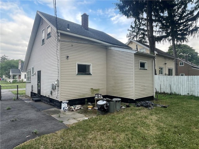 37 Outlook Dr, Irondequoit, NY 14622 - rear view of house with a chimney and a shingled roof