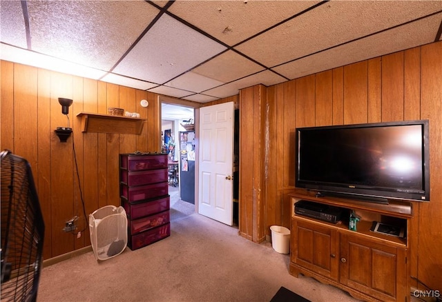103 Stanwix St, Rome, NY 13440 - living area with carpet flooring, wooden walls, and a paneled ceiling