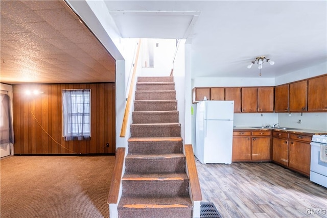 103 Stanwix St, Rome, NY 13440 - kitchen with white appliances, brown cabinets, and wood walls