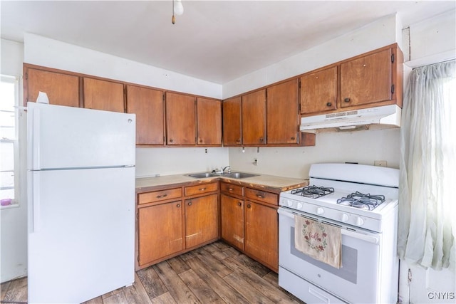 103 Stanwix St, Rome, NY 13440 - kitchen with white appliances, under cabinet range hood, wood finished floors, and plenty of natural light