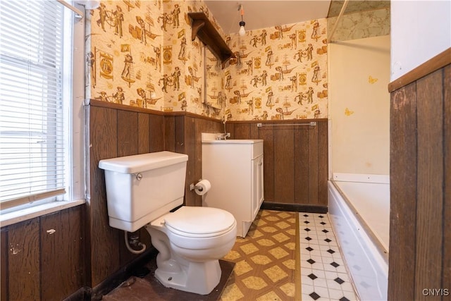 103 Stanwix St, Rome, NY 13440 - bathroom featuring wallpapered walls, wainscoting, tile patterned floors, a tub, and vanity