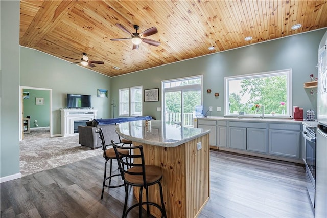 7156 County Line Rd, Naples, NY 14512 - kitchen with wooden ceiling, a ceiling fan, a kitchen island, open floor plan, and wood finished floors
