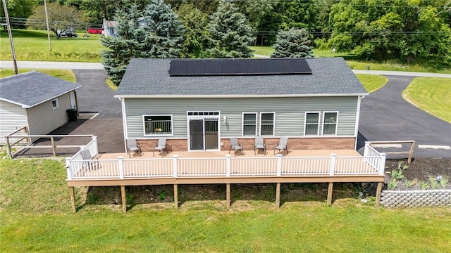 7156 County Line Rd, Naples, NY 14512 - back of property with solar panels, a yard, a wooden deck, and a shingled roof