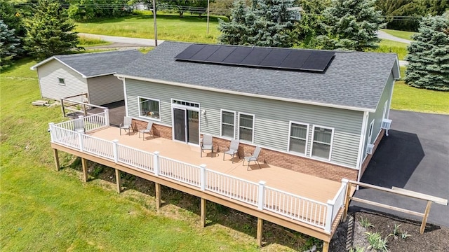 7156 County Line Rd, Naples, NY 14512 - back of property with solar panels, a lawn, and a wooden deck