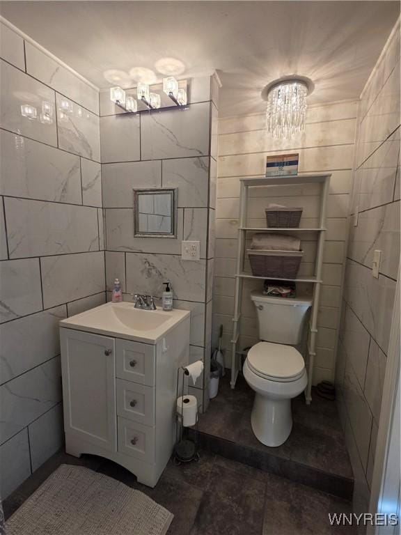 4049 River Rd, Lewiston, NY 14174 - half bath with a chandelier, vanity, and tile walls