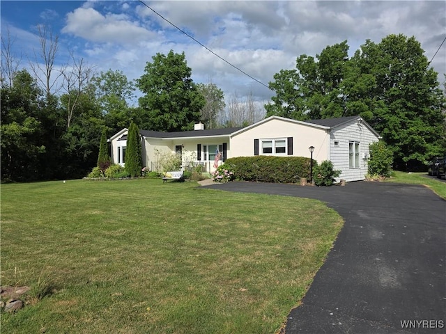 4049 River Rd, Lewiston, NY 14174 - view of front of house featuring a front lawn, a chimney, and driveway