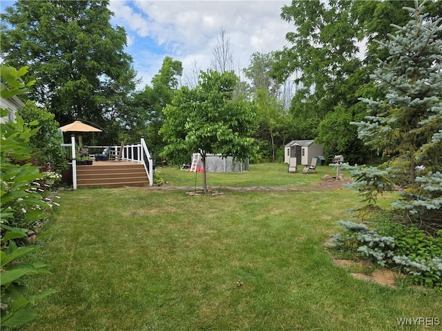 4049 River Rd, Lewiston, NY 14174 - view of green lawn with a shed and a wooden deck