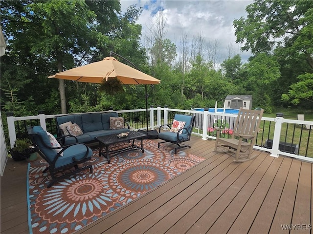 4049 River Rd, Lewiston, NY 14174 - wooden deck with outdoor lounge area, a storage shed, and an outdoor pool