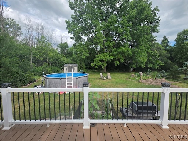 4049 River Rd, Lewiston, NY 14174 - wooden terrace featuring a lawn and a storage shed