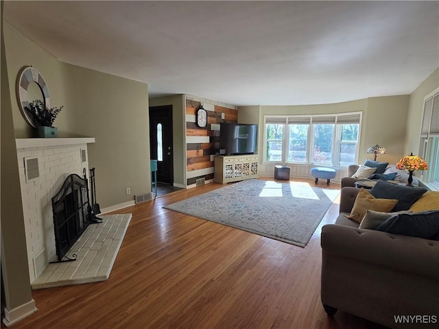 4049 River Rd, Lewiston, NY 14174 - living area featuring wood finished floors and a fireplace