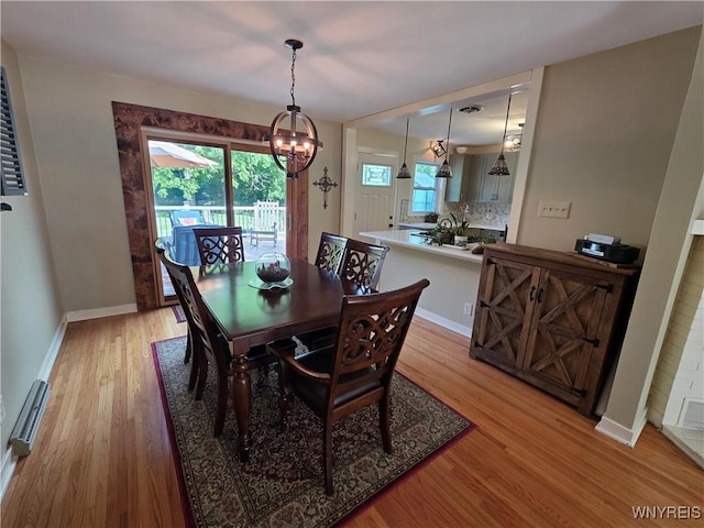 4049 River Rd, Lewiston, NY 14174 - dining space with a chandelier, light wood finished floors, and plenty of natural light