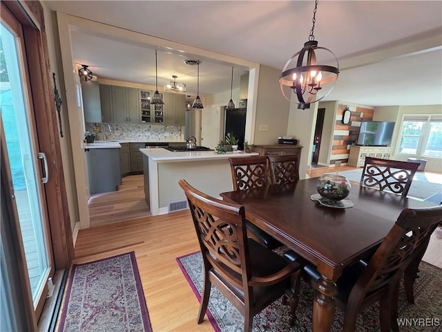 4049 River Rd, Lewiston, NY 14174 - dining area featuring light wood-style floors and a chandelier