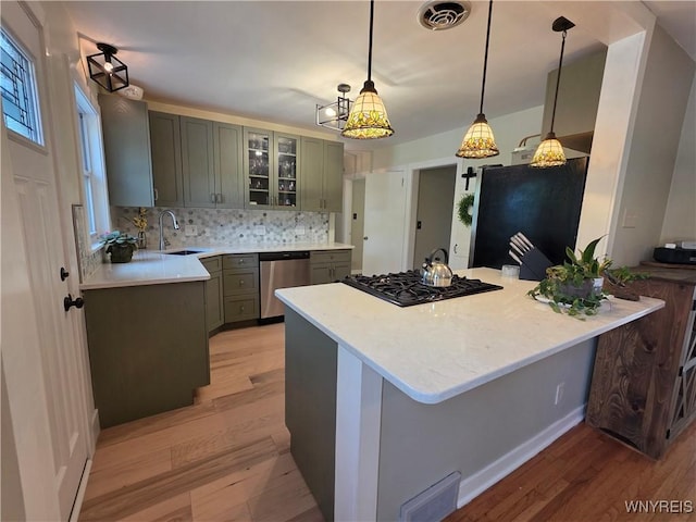 4049 River Rd, Lewiston, NY 14174 - kitchen featuring stainless steel dishwasher, freestanding refrigerator, light wood finished floors, and decorative backsplash