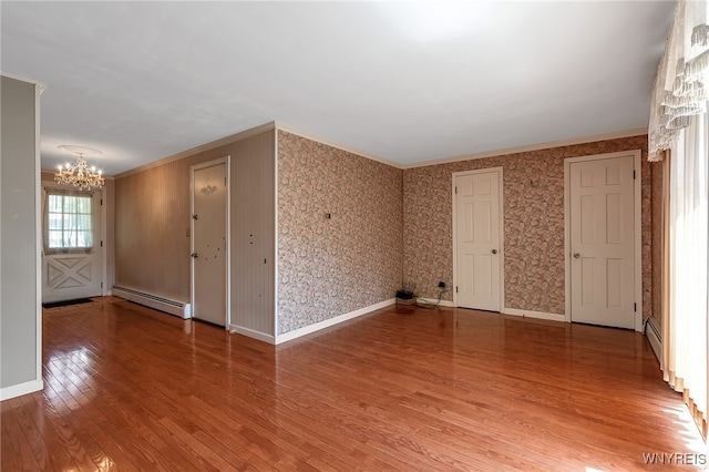 17 Frantzen Ter, Cheektowaga, NY 14227 - spare room featuring a chandelier, a baseboard heating unit, light wood finished floors, and ornamental molding