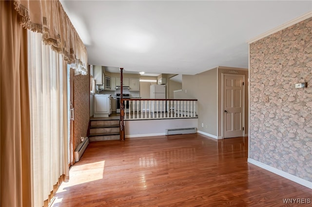17 Frantzen Ter, Cheektowaga, NY 14227 - unfurnished room with wallpapered walls, light wood-type flooring, a baseboard heating unit, and stairway