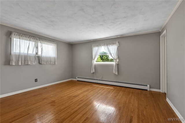 17 Frantzen Ter, Cheektowaga, NY 14227 - unfurnished room with baseboard heating, ornamental molding, wood finished floors, and a textured ceiling