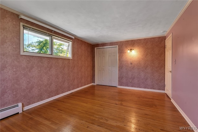 17 Frantzen Ter, Cheektowaga, NY 14227 - unfurnished room with baseboard heating, wood-type flooring, and crown molding