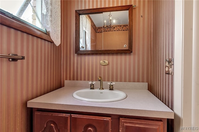 17 Frantzen Ter, Cheektowaga, NY 14227 - bathroom with wallpapered walls, vanity, and a chandelier
