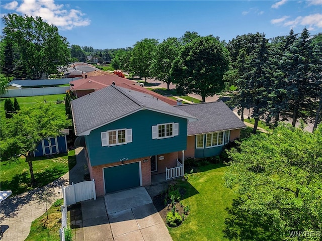 17 Frantzen Ter, Cheektowaga, NY 14227 - view of front of home with brick siding, concrete driveway, an attached garage, a storage unit, and roof with shingles