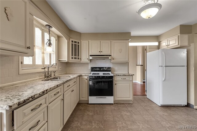 17 Frantzen Ter, Cheektowaga, NY 14227 - kitchen with white appliances, under cabinet range hood, tasteful backsplash, and glass insert cabinets